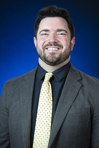 A man in suit with yellow tie 