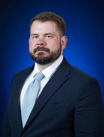 a bearded man in a suit