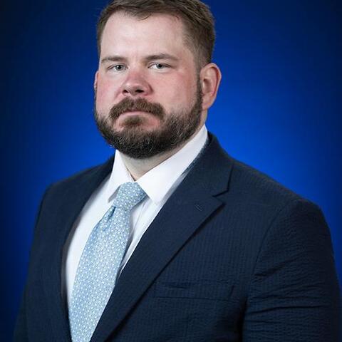 a bearded man in a suit